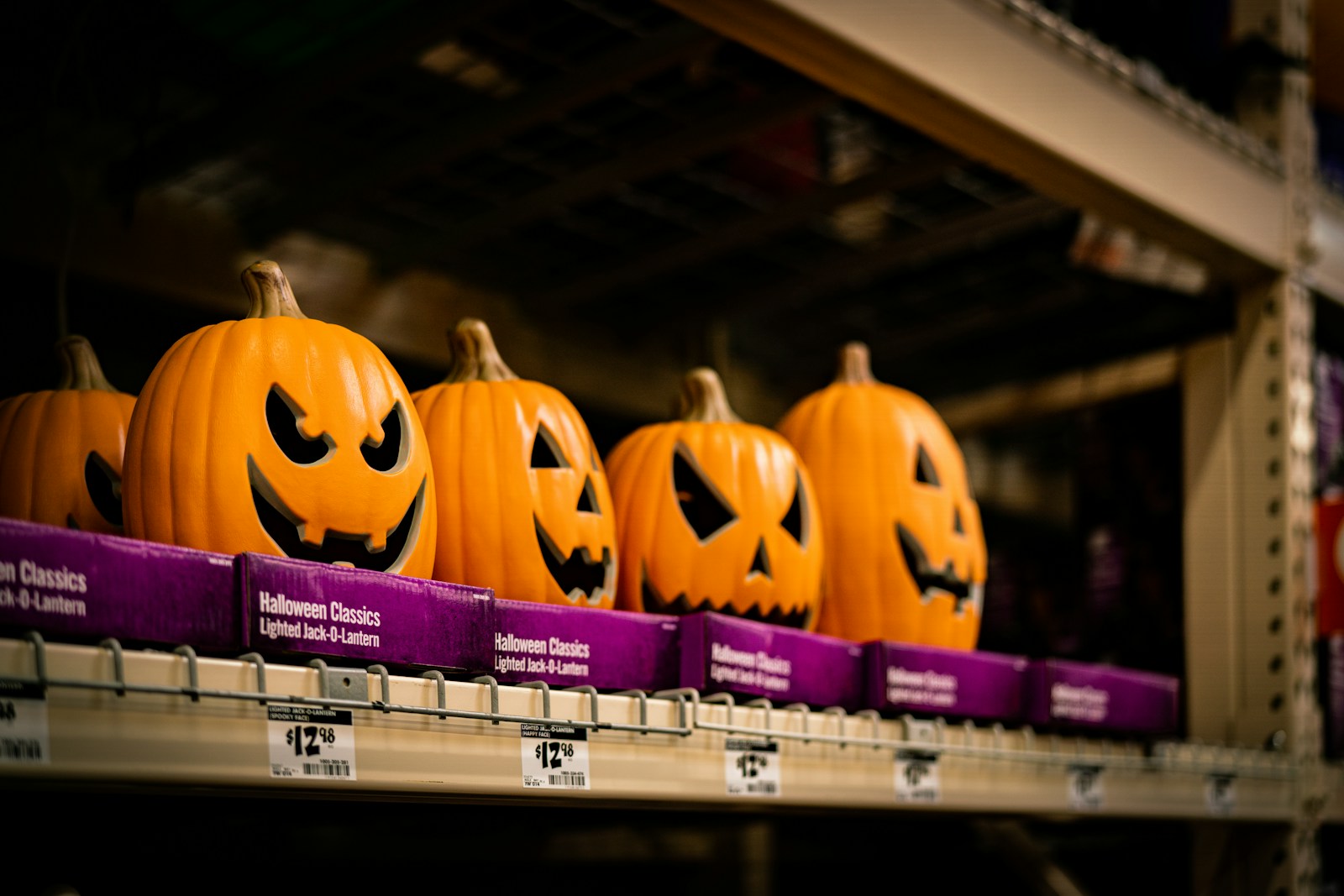 a row of jack o lantern pumpkins on a shelf